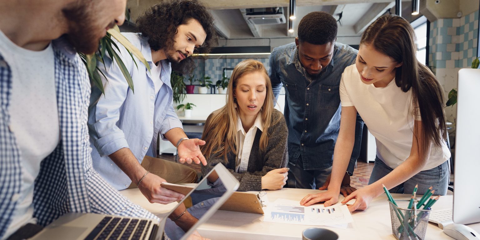 a group of people in a meeting in an office setting