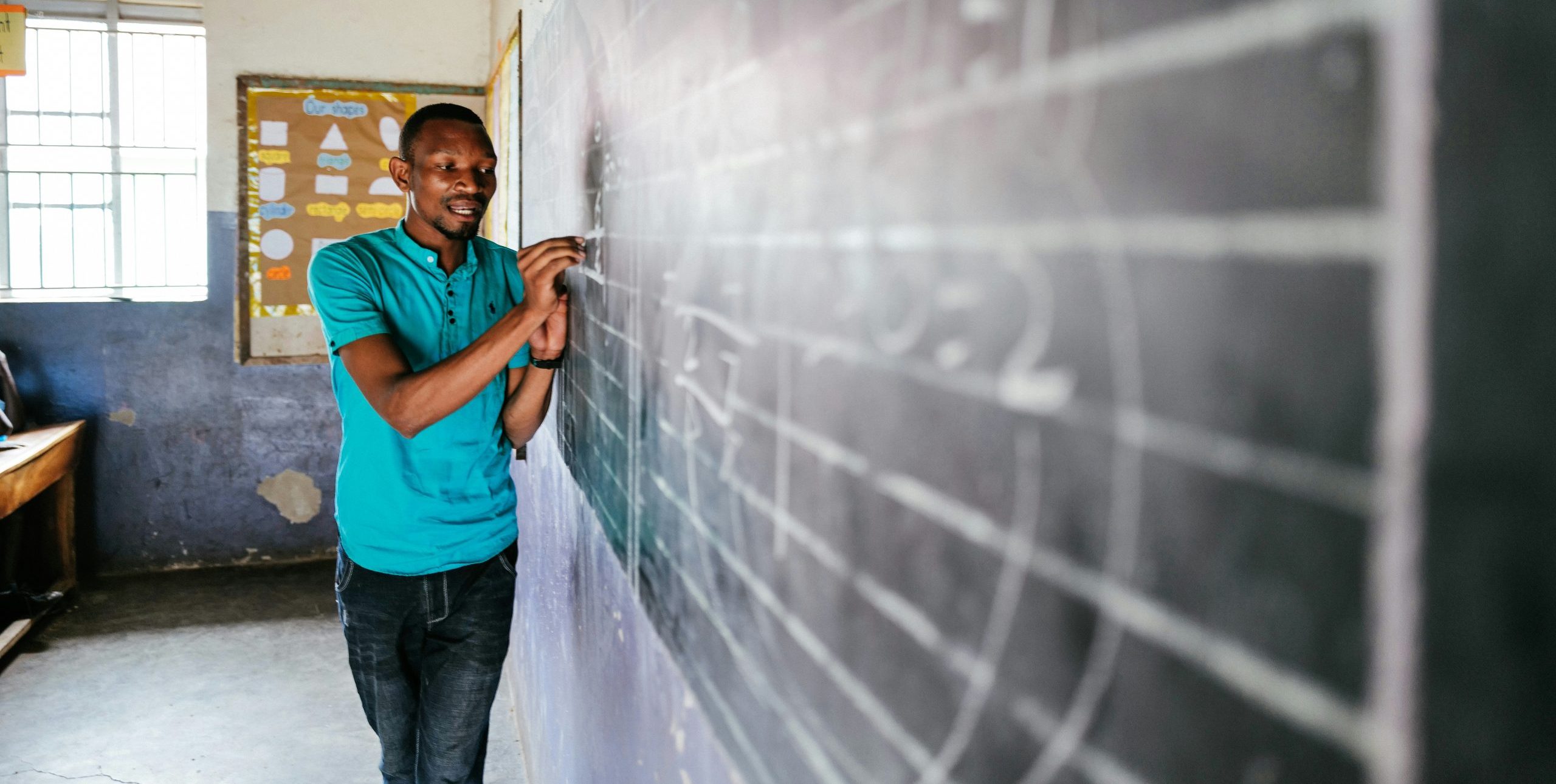teacher using a chalkboard